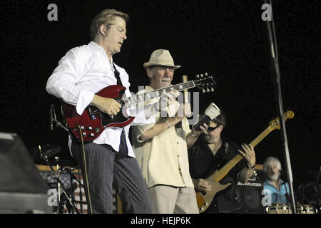 From left, John Jorgensen, former guitarist for the Desert Rose Band, and Alex Ligertwood, former lead singer of the band Santana, perform 'Oye Como Va' during a Morale, Welfare, and Recreation concert at Camp Liberty, Iraq, July 5. Ligertwood was part of Santana for 16 years and performed several of their hit songs, including 'I'm Winning' and 'Home Bound.' Rock, Pop Masters performs at Camp Liberty in Iraq 296876 Stock Photo