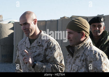 Lt. Col. John E. McDonough, left, the commanding officer of 2nd Battalion, 2nd Marine Regiment, and his interpreter, Ray, talk to members of the 6th Battalion, 3rd Brigade, 205th Corps, Afghan national army, after their graduation ceremony at Patrol Base Shamshad, Nov. 26, 2009. Twenty-eight members of 6th Battalion graduated after two weeks of training headed by soldiers from 2nd Battalion, 508th Parachute Infantry Regiment, 4th Brigade Combat Team, 82nd Airborne Division. Patrol Base Shamshad -d Stock Photo