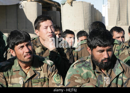 Members of the 6th Battalion, 3rd Brigade, 205th Corps, Afghan national army, listen to a speech by Lt. Col. John E. McDonough, the commanding officer of 2nd Battalion, 2nd Marine Regiment, after their graduation ceremony at Patrol Base Shamshad, Nov. 26, 2009. Twenty-eight members of 6th Battalion graduated after two weeks of training headed by soldiers from 2nd Battalion, 508th Parachute Infantry Regiment, 4th Brigade Combat Team, 82nd Airborne Division. Patrol Base Shamshad -c Stock Photo