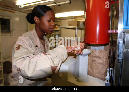 GUANTANAMO BAY, Cuba – Navy Petty Officer 3rd Class Iesha Savage, a hospital corpsman with Joint Task Force Guantanamo's Joint Medical Group, measures a prescription at the detainee hospital, Dec. 7, 2009.  The JMG provides first-class medical care to detainees at JTF Guantanamo.  JTF Guantanamo conducts safe, humane, legal and transparent care and custody of detainees, including those convicted by military commission and those ordered released by a court. The JTF conducts intelligence collection, analysis and dissemination for the protection of detainees and personnel working in JTF Guantanam Stock Photo
