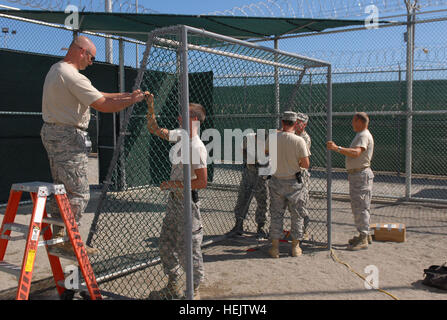 Members of the Arkansas Air National Guard, 188th Tactical Fighter Wing, deployed to Joint Task Force Guantanamo's 474th Expeditionary Civil Engineering Squadron, complete finishing touches on soccer goals for detainees inside the recreation yard of Camp 6, Dec. 8, 2009. The 474th ECES supports JTF Guantanamo by maintaining the Expeditionary Legal Complex and Camp Justice facilities and infrastructure, along with detention facility improvements. Beefing Up Detention Facilities 233638 Stock Photo