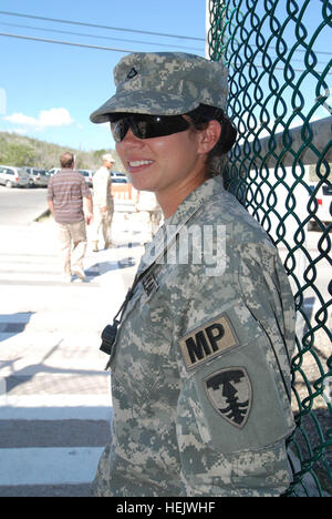 GUANTANAMO BAY, Cuba – Army Pfc. Shannon McCuster, a military policeman with Joint Task Force Guantanamo's 115th Military Police Company, provides security at a checkpoint, Dec. 16, 2009.  The 115th MP Company is a part of the Rhode Island Army National Guard and here on a yearlong deployment providing external security for the detention facilities at Joint Task Force Guantanamo. JTF Guantanamo conducts safe, humane, legal and transparent care and custody of detainees, including those convicted by military commission and those ordered released by a court. The JTF conducts intelligence collecti Stock Photo