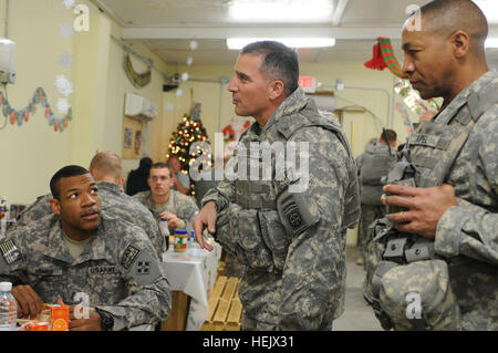 U.S. Army Sgt. 1st Class LaMont James (left), security patrol team leader and platoon sergeant for 4th platoon, Battery B, 2nd Battalion, 77th Field Artillery Regiment and resident of Brinkley, Ark., shares Christmas conversation with U.S. Army Maj. Gen. Curtis M. Scaparrotti, the Combined Joint Task Force 82 commanding general, and Command Sgt. Maj. Thomas R. Capel, during a surprise visit to Torkham in eastern Afghanistan's Nangarhar province. Maj. Gen. Scaparrotti Visits Torkham Gate Keepers 236297 Stock Photo