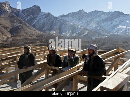 Afghan construction workers receive guidance from engineers of the Panjshir Provincial Reconstruction Team while inspecting a girls' school project in Anaba district, Panjshir province, Afghanistan, on January 5, supporting Operation Enduring Freedom reconstruction efforts. Stock Photo