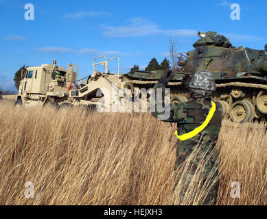 Soldiers from Fort Knox's 233rd Transportation Company work to unload an M60 series tank from a Heavy equipment transporter to one of the post's tank ranges. The mission gave 233rd Trans. Co. Soldiers an opportunity to refresh and improve their skills while ultimately preparing the unit for the movement of the Patton Museum to Fort Benning, Ga. In the movement of the Patton Museum, the 233rd Trans. Co. would have a key role in the transporting of equipment, making this mission all the more beneficial. 233rd Transportation Company Transports Vehicles to Improve Ranges, Gain Experience 238864 Stock Photo