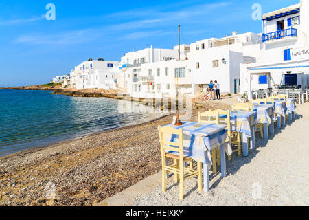 PAROS ISLAND, GREECE - MAY 19, 2016: taverna tables on beach in Naoussa village on Paros island, Greece. Stock Photo