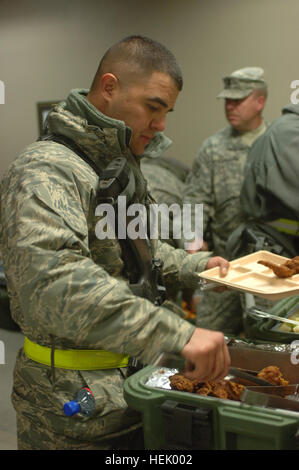 Military members enjoy a hard earned meal after a long day of treating Afghan survivors of the Salang Pass. Military members at Bagram Airfield, Afghanistan, provided medical aid and humanitarian assistance to Afghan local national who were victims of an avalanche near Salang Pass, Feb. 9. Salang Avalanche 250005 Stock Photo