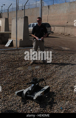 Shawn Wyzlic, a robot technician for the Joint Robotics Repair Detachment and native of Wixom, Mich., tests a robot used to disarm and identify explosives at the Joint Robotics Repair Facility on Camp Victory, Baghdad, Iraq, March 2, 2010. The robots come to the facility when needing repairs or a unit is leaving Iraq so they can be cleaned and given to another unit in need of them. Joint Robotics Repair Detachment keeps robots mission ready 269098 Stock Photo