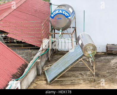 Solar hot water heater with holding tank installed on rooftop. Stock Photo