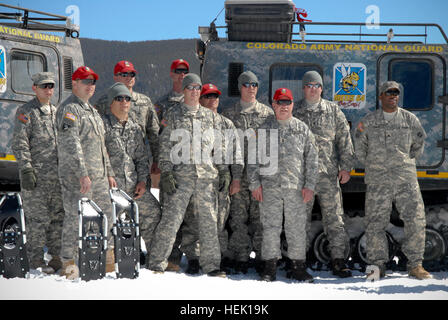Members of the Colorado Army National Guard's Snow Response Team pose in front of two M973A1 Small Unit Support Vehicles, aka SUSVs. Clad in emergency lights and digital camouflage, the vehicles, which are capable of traversing almost any terrain, are a relatively unknown asset available to state and local emergency rescue teams during nearly every type of disaster, state emergency or search and rescue mission. Snow Response Team Training 266033 Stock Photo