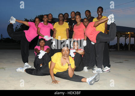 GUANTANAMO BAY, Cuba – Army Lt. Nichole Payne (center) poses with the Praise and Worship Dance Team that she trains and choreographs, May 9, 2010. The dance team performed for the first time in a secular setting at the recent Sunset Festival. JTF Guantanamo conducts safe, humane, legal and transparent care and custody of detainees, including those convicted by military commission and those ordered released by a court. The JTF conducts intelligence collection, analysis and dissemination for the protection of detainees and personnel working in JTF Guantanamo facilities and in support of the War  Stock Photo