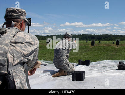 Indiana Army National Guard Soldiers from the 81st Troop Command qualify with their M9 pistol in the kneeling position during a training exercise June 19 at Camp Atterbury Joint Maneuver Training Center in central Indiana. The Soldiers of the 381st, 384th and 387th Military Police Companies along with the 215th Area Support Medical Company are currently training at Camp Atterbury in preparation for an upcoming humanitarian aid mission in Haiti. Military Police fire pistols, Train for Haiti Deployment 292748 Stock Photo