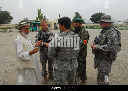 Soldiers from Civil Military Operations teams from the 1-178th Field Artillery Battalion, South Carolina Army National Guard and 1-101st Field Artillery Battalion, Massachusetts Army National Guard, and the Afghan National Army meet with Ghulam Farooq Masafir (left), principal, Khush Hallkhan High School. The soldiers from South Carolina, Massachusetts and the Afghan National Army were there to meet with school officials about potential reconstruction projects. Khush Hallkhan High School is a boarding school for 2,500 boys from twenty-four different Afghan provinces. Afghan National Army and N Stock Photo