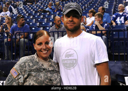 Indiana Army National Guard Sgt. Beth Gorenc, 38th Combat Aviation Brigade public affairs sergeant, poses with tennis superstar Andy Roddick prior to the Indianapolis Colts, New York Giants football game in Indianapolis, Sept. 19, 2010. Gorenc returned from a yearlong mobilization in support of Operation Iraqi Freedom in June. 38th CAB Flag Presentation to Colts 321100 Stock Photo