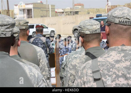 Company A, 1st Battalion, 68th Armor Regiment, 3rd Advise and Assist Brigade, 4th Infantry Division as the Shurta 1st Iraqi Police Emergency Response Unit receive their training certificates. US Soldiers award Iraqi Police training efforts 335008 Stock Photo