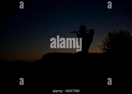 A policeman with 2nd Battalion, 3rd Afghan National Civil Order Police Brigade, provides security during a late afternoon patrol Nov. 6, 2010, with U.S. Special Forces in Zhari District, Kandahar province, Afghanistan. The ANCOP from 2nd Bn. are partnered with members of Special Operations Task Force - South. Night falls on Afghan police, security presence continues 340485 Stock Photo