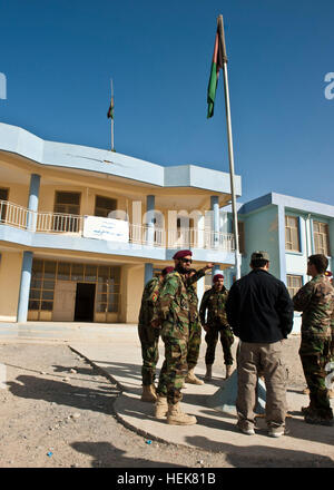 Afghan soldiers with 3rd Commando Kandak and U.S. Soldiers with Special Operations Task Force - South meet outside The Sayeed Shied Bacha School before heading inside to distribute jackets, bookbags and other supplies to the school children, Dec. 9, 2010, in Kandahar Province, Afghanistan. (U.S. Army photo by Spc. Daniel P. Shook / Special Operations Task Force - South)(Released). Afghan Commandos, US Soldiers reach out to community 348574 Stock Photo