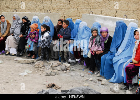 Dozens of women and children sit in line waiting for medical treatment at the free clinic at Bagram Air Field's Korean Hospital Jan. 29. The clinic included medical personnel from Afghanistan, Korea, United Arab Emirates, the U.S. Army and Army Reserve and U.S. Navy who treated more than 200 patients. USSF doctors assist in treating more than 200 Afghan locals 361872 Stock Photo