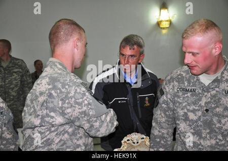 Sgt. Nicholas Allen (foreground, left), an engineer team leader with the 228th Engineer Company, 1st Battalion, 63rd Armored Regiment, 2nd Advise and Assist Brigade, 1st Infantry Division, United States Division - Center and an Allentown, Pa., native, shakes hands with U.S. Rep. Todd Platts, R-Pa., (second from right), a member of the House Armed Services Committee, Feb. 2 at Camp Liberty, Iraq. (Photo by: Staff Sgt. Justin Phemister) 'Dragon' Battalion engineer company hosts US congressman 365497 Stock Photo