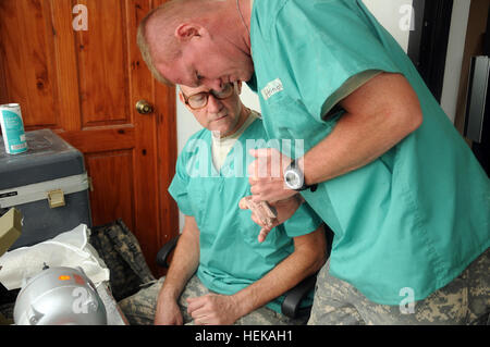 U.S. Army Reserve dental laboratory technicians, Sgt's Robert Arrington and Tim Lewis, 912th Medical Company, from Independence, Mo., inspect a model of a patient's teeth that was used to form a flipper (holding bracket) and teeth for a patient at the Saint Nicolas Hospital where Task Force Bon Voizen dental operations were taking place, June 6, 2011. Task Force Bon Voizen, New Horizons Haiti 2011, is a Commander, U.S. Southern Command sponsored, U.S. Army South conducted, joint foreign military interaction/humanitarian exercise under the command of the Louisiana National Guard. Task Force Bon Stock Photo