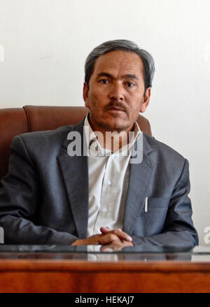 In this photo provided by International Security Assistance Force Regional Command (South) Qurban Ali Orugani, Daykundi provincial governor, sets at his desk during a meeting with ISAF RC-South leaders to discuss potential aid projects that could take place within Daykundi. Qurban Ali Oruzgani in 2011-cropped Stock Photo