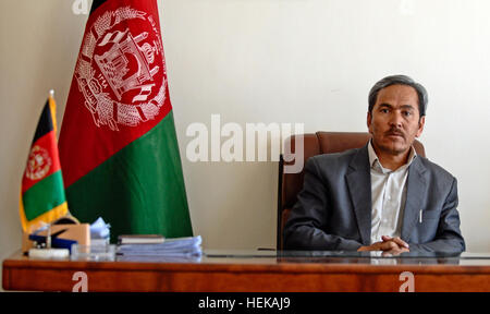 In this photo provided by International Security Assistance Force Regional Command (South) Qurban Ali Orugani, Daykundi provincial governor, sets at his desk during a meeting with ISAF RC-South leaders to discuss potential aid projects that could take place within Daykundi. Qurban Ali Oruzgani in 2011 Stock Photo