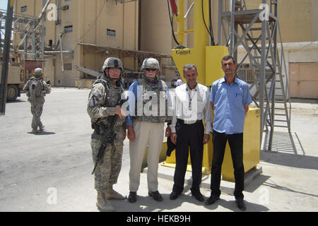 Lt. Col Cameron Cantlon, left, Commander of 6th ‘Saber’ Squadron, 9th Cavalry Regiment, 3rd Advise and Assist Brigade, 1st Cav. Division, and a Ettrick, Wis. native; George Stickels, second from left, Provincial Reconstruction Team and United States Department of Agriculture member; and two project managers at the Al Kut Grain Silo stand by the new Apollo Gamet Mechanical Grain Probe, June 22, 2011 during the ribbon cutting ceremony conducted at the grain silo. The mechanical grain probe provided by the PRT will allow the grain to be properly graded and stored at the silo. (U.S. Army photo by  Stock Photo