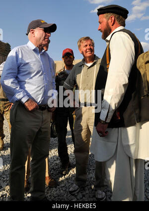 KONAR PROVINCE, Afghanistan – Senators John McCain and Lindsey Graham speak with a U.S. Special Operations Forces team leader after having met with a village elder to discuss future operations in Mangwel village, Khas Konar district, Konar province, July 4. The senators met with various SOF team members to discuss Afghan Local Police and Village Stability Operations. (U.S. Army photo by Sgt. Lizette Hart, 19th Public Affairs Detachment) Senators visit special operations forces soldiers in eastern Afghanistan 423829 Stock Photo