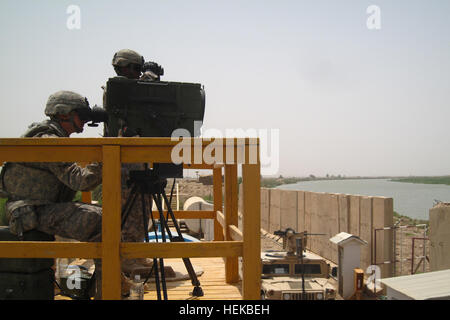 Soldiers from 1st Platoon, Bandit Troop, 6th ‘Saber’ Squadron, 9th Cavalry Regiment, 3rd Advise and Assist Brigade, 1st Cavalry Division, utilize a Long-Range Advance Scout Surveillance System in order to identify insurgents emplacing indirect fire assets on July 6, 2011 near Contingency Operating Base Delta, Iraq. Eliminating insurgent’s capabilities to use indirect fire is a top priority for Saber Squadron, as it poses a great threat not only to U.S. Security Forces, but also the local population. (Photo by 2nd Lt. Daniel Elmblad) Saber Squadron counters indirect fire operations 426031 Stock Photo