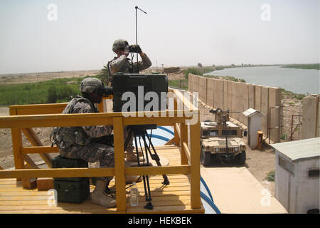 Soldiers from 1st Platoon, Bandit Troop, 6th ‘Saber’ Squadron, 9th Cavalry Regiment, 3rd Advise and Assist Brigade, 1st Cavalry Division, utilize a Long-Range Advance Scout Surveillance System in order to identify insurgents emplacing indirect fire assets on July 6, 2011 near Contingency Operating Base Delta, Iraq. Eliminating insurgent’s capabilities to use indirect fire is a top priority for Saber Squadron, as it poses a great threat not only to U.S. Security Forces, but also the local population. (Photo by 2nd Lt. Daniel Elmblad) Saber Squadron counters indirect fire operations 426030 Stock Photo