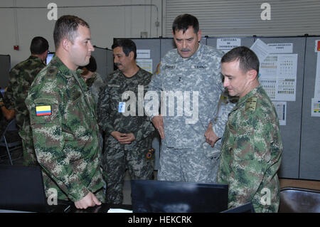 U.S. Army Maj. Gen Simeon Trombitas (center), Commander of U.S. Army South and Commander of the Multi National Forces South for Panamax 2011, check the progress of the computer-simulated exercise with Colombian soldiers assigned to the Combined Forces Land Component Command (CFLCC) in San Antonio Texas on August 22, 2011. PANAMAX is a multinational exercise that brings together sea, air and land forces in a joint and combined operation focused on defending the Panama Canal. This year, 16 nations from the Americas are participating in an effort to provide interoperability training for the parti Stock Photo
