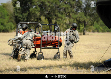 A CH-47 Chinook helicopter crew roll out the Bambi Bucket to install it on the aircraft. Texas National Guard crews launched out of the Austin Army Aviation Facility to fight wild fires threatening homes and property near Bastrop, Texas, Sept. 6, 2011. Texas National Guard helicopters battle Bastrop blaze 110906-A-FG822-003 Stock Photo