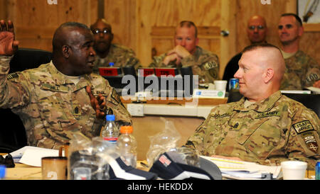 In this photo provided by ISAF Regional Command South, Army Command Sgt. Maj. Marvin L. Hill, ISAF command sergeant major, further explains part of a briefing at the monthly ISAF Command Sergeant Major Conference at Kandahar Airfield Sept. 10. The focus of this conference was how to maximize safety, manpower and efficiency among the units in RC-S, particularly the utilization of enablers- tools and robotics that help service members identify improvised explosive devices before they can detonate. CSM Hill at the CSM Conference 454590 Stock Photo