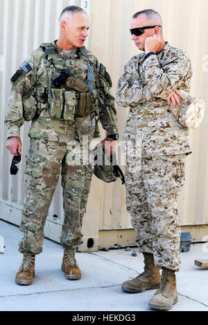 In this photo provided by ISAF Regional Command South, Marine Corps Gen. John R. Allen, ISAF commander, receives information from Army Maj. Gen. James L. Terry, RC-South and 10th Mountain Division (Light) commander, at Kandahar Airfield, Sept. 12, 2011. Allen stopped to change planes on his way to a conference with Terry, as well as other U.S. and Afghan leaders, to discuss reintegration. Maj. Gen. Terry speaks with ISAF commander Gen. Allen at Kandahar Airfield 455823 Stock Photo