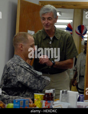 John McHugh, Secretary of the Army, greets Staff Sgt. Joshua Bell, a gunnery sergeant with 1st Battalion, 7th Field Artillery Regiment, 2nd “Dagger” Advise and Assist Brigade, 1st Infantry Division, United States Division – Center, and a Santa Rita, Guam, native, prior to a dinner between McHugh and several soldiers from around USD-C, including two Dagger Brigade soldiers, Sept. 14, 2011, at Camp Liberty, Iraq. During the dinner, McHugh took the opportunity to answer questions and concerns of the soldiers present, including the proposed new retirement system. Secretary of the Army talks issues Stock Photo