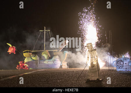 Brighton, UK. 21st December, 2016.  Thousand of spectators gathered to watch The Burning the Clocks on Brighton Beach, Thousands of clocks are loaded onto the boat on the beach then set on fire and a with firework finale to mark the winter solstice, England.© Jason Richardson / Alamy Live News Stock Photo