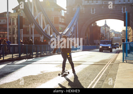Tower Bridge, London, UK. 22nd Dec, 2016. A skateboarder crosses the bridge ahead of the first cars. Tower Bridge, the 122-year old iconic landmark on the River Thames, reopens to traffic following a 3 month closure for essential maintenance work to its Grade I listed structure. Credit: Imageplotter News and Sports/Alamy Live News Stock Photo