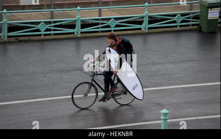 Brighton Sussex UK 23rd December 2016 - A surfer makes his way to the beach in Brighton as Storm Barbara is expected to hit Britain later today with winds forecast to reach up to 90 mph in Scotland   Credit: Simon Dack/17�Թ����� Live News Stock Photo