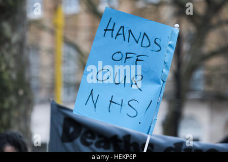 Whitehall, London, UK. 23 Dec, 2016. Health campaigners make a 'Howl for Protest for the NHS', howling, blowing whistles and banging pans at the rally outside Downing Street in Whitehall, on the day that contracts are signed for all 44 areas of the country to implement the government's 'Sustainability and Transformation Plans' (STP). Credit: Dinendra Haria/Alamy Live News Stock Photo