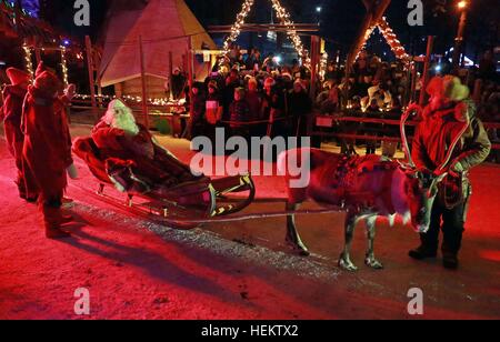 Tourists on a reindeer ride at the Santa Claus Village, in Rovaniemi,  Finland. Rovaniemi is the provincial capital of Finnish Lapland and is  situated on the Arctic Circle, it is also the