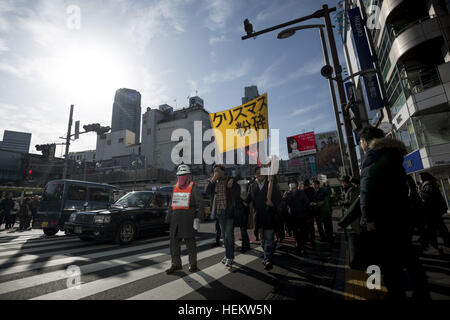 Tokyo, Tokyo, Japan. 24th Dec, 2016. Protesters hold banner reading 'Smash Christmas Day'' as they shout slogans during a march at Tokyo's Shibuya shopping and amusement district. The members of the group known as Kakuhidou, gathered and marched on Saturday against what they called the ''Christmas capitalists' BLO, D-soaked plot to victimize consumersâ © Alessandro Di Ciommo/ZUMA Wire/Alamy Live News Stock Photo