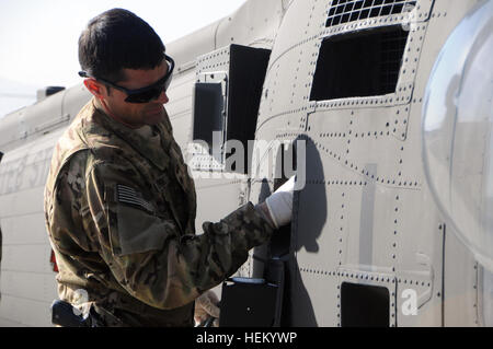 Paramus, N.J., native U.S. Army Staff Sgt. Mitchell Bethke, medic and platoon sergeant with the 3rd Forward Support Medevac Team, Company C, 3rd Battalion, 82nd Combat Aviation Brigade, prepares to collect a fuel sample from a UH-60M Black Hawk helicopter as part of a pre-flight inspection Oct. 27 at the helicopter pad on FOB Shank. The morning of their shift, 3rd FSMT soldiers conduct a thorough inspection of the helicopter and their equipment, stock medical supplies and stage their gear on the aircraft. “During checks, we look at our medical equipment and make sure it’s ready to go. We make  Stock Photo