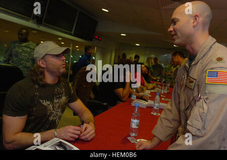 Photo by Sgt. Thomas Day, 40th Public Affairs Detachment Country music artist Darryl Worley signs a photo for a Third Army Soldier and country music fan as part of a USO Tour at Camp Arifjan. Kuwait Dec. 14. Darryl Worley Kuwait 6 Stock Photo