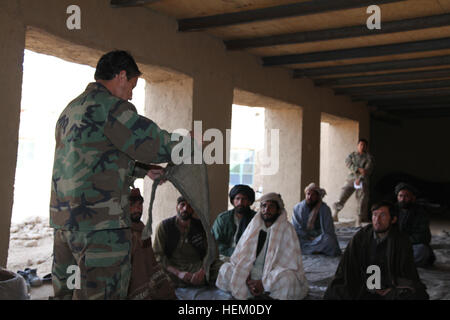 Afghan Local Police candidates receive first aid training from Afghan National Army Special Forces in Kajran, Daukundi province, Afghanistan, Nov. 23, 2011. The ALP are being trained to become well rounded patrolmen to help maintain security in the surrounding area. ALP academy 111123-A-NC985-010 Stock Photo