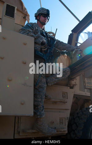 Lt. Ken Pitts, a platoon leader assigned to D Company, 2nd Battalion, 325th Airborne Infantry Regiment, 2nd Brigade, 82nd Airborne Division, dismounts his armored vehicle along a highway in Baghdad on Nov. 18. Paratroopers with D Company are responsible for securing the route for convoys traveling south to Kuwait. The 2nd Brigade is the last brigade in Baghdad and is facilitating the withdrawal of U.S. military forces from Iraq. Pitts is a native of Edmond, Okla. Infantrymen ensure smooth passage of US military forces through Baghdad 489516 Stock Photo