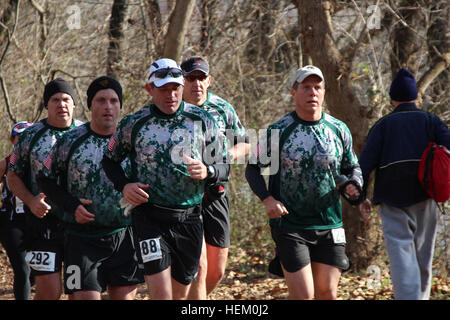 Special Forces Green Berets from Fort Bragg maintain their easy stride as they approach the half-way mark of the JFK 50 Miler. The runners from left to right are, a fellow Green Beret, Cecil Marson, Mike Sullivan, Fred Dummar and Alan Shumate. The race was first held in the spring of 1963, and although open to the public, the JFK 50 Mile is in spirit a military race. The initial inspiration behind the event came from then President John F. Kennedy challenging his military officers to meet the requirements that Teddy Roosevelt had set for his own military officers at the dawn of the 20th Centur Stock Photo