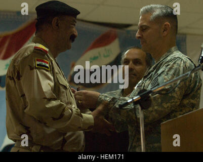 Task Force Marne commanding general, Maj. Gen. Tony Cucolo, pins Maj. Gen. Abul Amier Ridha Mohammed Al-Zaidi, outgoing commander for 12th Division, Iraqi army, with the Meritorious Service Medal, during the 12th Div. IA change of command ceremony at Kirkuk Training Center, April 20. Distinguished guests of the event included: Cucolo; Task Force Marne deputy commanding general, Maneuver, Brig. Gen. Patrick J. Donahue, II; Col. Larry Swift, commander of 1st Brigade Combat Team, 1st Armored Division out of Fort Bliss, Texas; Lt.  Col. Charles Freeman, senior advisor 12th Military Transition Team Stock Photo