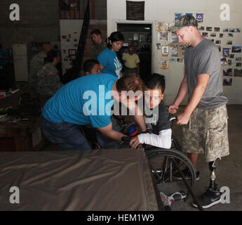 U.S. Army combat veteran and physical therapy students provide customized wheelchairs and assistance to children with physical and mental disabilities at Hope Haven, Guatemala, as part of the HSV-2 Swift Southern Partnership Station mission. Stock Photo