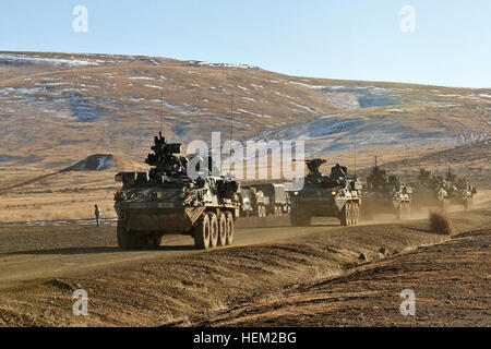 Soldiers of 1st Battalion, 38th Infantry Regiment, 4th Stryker Brigade Combat Team, 2nd Infantry Division drive past Range 5 where the brigade’s military police platoon was conducting a .50 caliber machine gun and MK 19 grenade launcher range Feb. 4 here. Soldiers of 4th SBCT, 2nd Inf. Div. are taking part in Exercise Raider Focus, a month-long brigade training exercise designed to challenge the ability of leaders and soldiers to conduct full spectrum operations as a combined arms team. Exercise Raider Focus continues 120204-A-BY764-009 Stock Photo