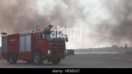 Royal Thai Air Force fire fighters use their fire truck for its hose as a back up measure during a demonstration held in support of Exercise Cobra Gold 2012 at Wing One Royal Thai Airforce Base, Nakhon Ratchasima, Kingdom of Thailand, Feb. 9, 2012. The demonstration consisted of joint efforts in fire rescue and medical safety procedures by participating nations in CG 12. The exercise improves the capability to plan and conduct combined joint operations, building relationships between partnering nations and improving interoperability across the Asia-Pacific region. Exercise Cobra Gold 2012 1202 Stock Photo